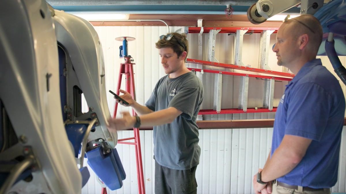 Technician working through a checklist at a coaster seat